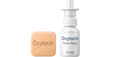 Oxytocin nasal spray bottle next to an oxytocin tablet.
