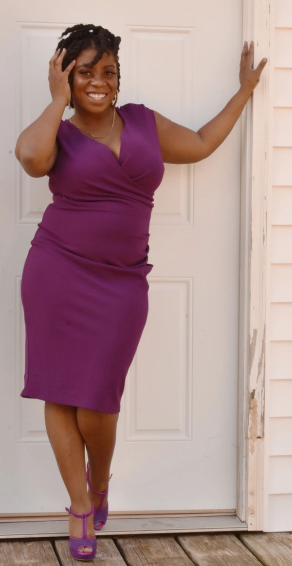 Model wearing purple, sleeveless, "criss-cross" chested dress (above the knee) with matching shoes)