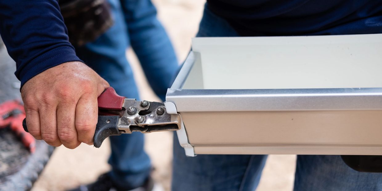 a man fixing a metal piece with a tool 