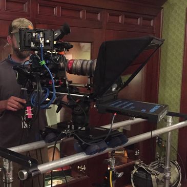 Teleprompter mounted to camera on a slider
