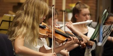Wind players and string players in one group forming a combined orchestra and band in one.