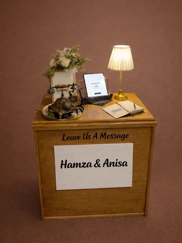 A wooden message box with vintage phone, tablet, lamp, and flowers for Hamza &amp; Anisa.