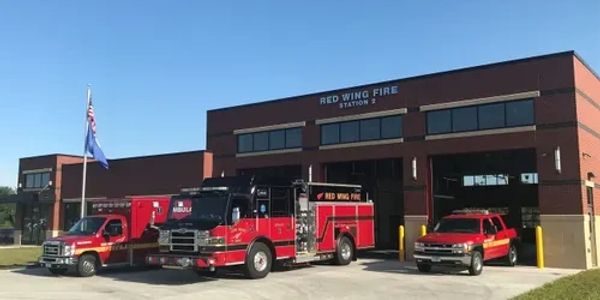 Red Wing Fire Station 2 with fire trucks parked outside on a sunny day.