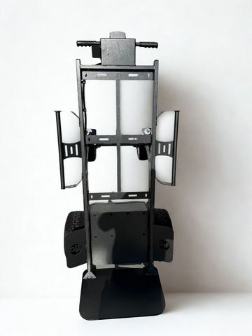 Top view of a black metal frame with wheels and handles on a white background.