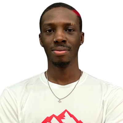 Portrait of a man with nose ring, earrings, and red streak in hair wearing a white shirt.