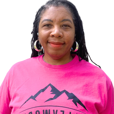 Woman in a bright pink shirt with mountain design.