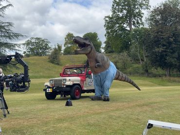 Dinosaur costume beside JP04 Jurassic Bake Jeep on set