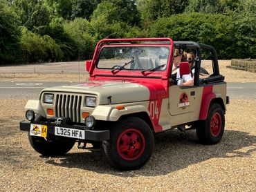 JP04 Jurassic Park Jeep with passengers driving on gravel