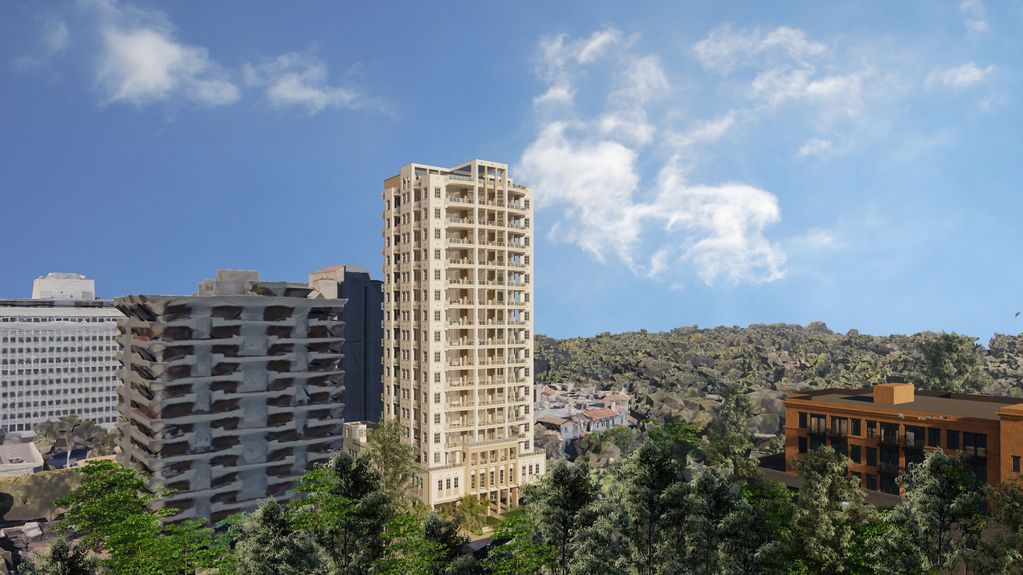 Rendered image showing  an aerial view of a new building surrounded by trees and other apartments.