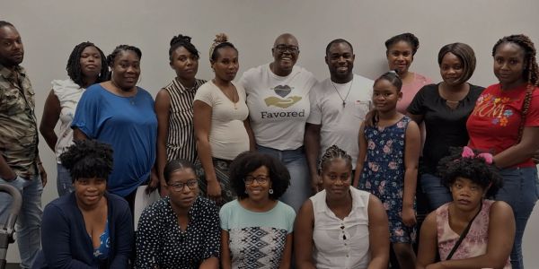 Group photo of smiling people indoors.