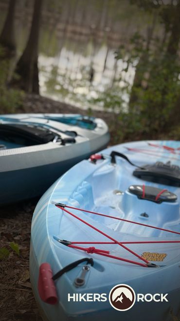 Kayaks Resting on the shore of a lake.