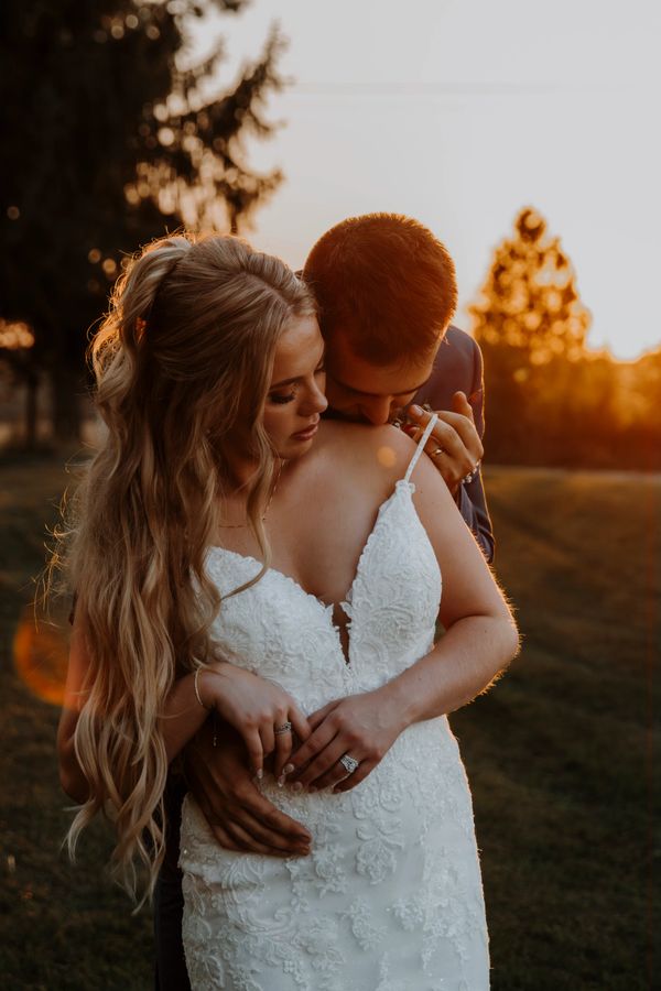 Bride and groom sharing an intimate moment at sunset.