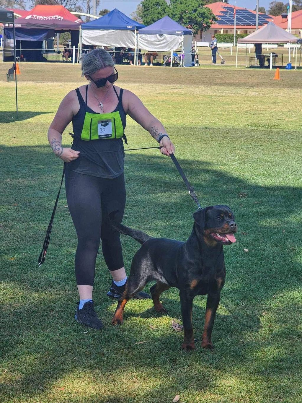 Woman with a Rottweiler dog at an outdoor event with a top rottweiler pedigree Vanaheim Nordic Queen