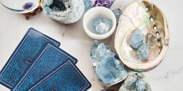 Image of a blue tarot deck and blue crystals