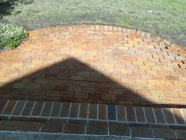An after picture of a clean pressure washed brick patio. 