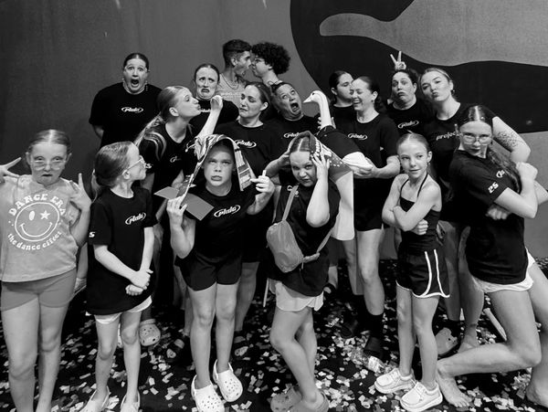 A lively group of young dancers making funny faces and playful poses.