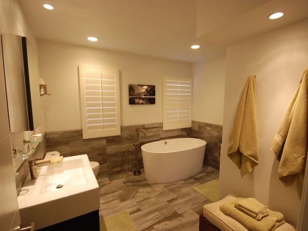 Custom bathroom with vessel tub and wall hung vanity, custom grey tile throughout