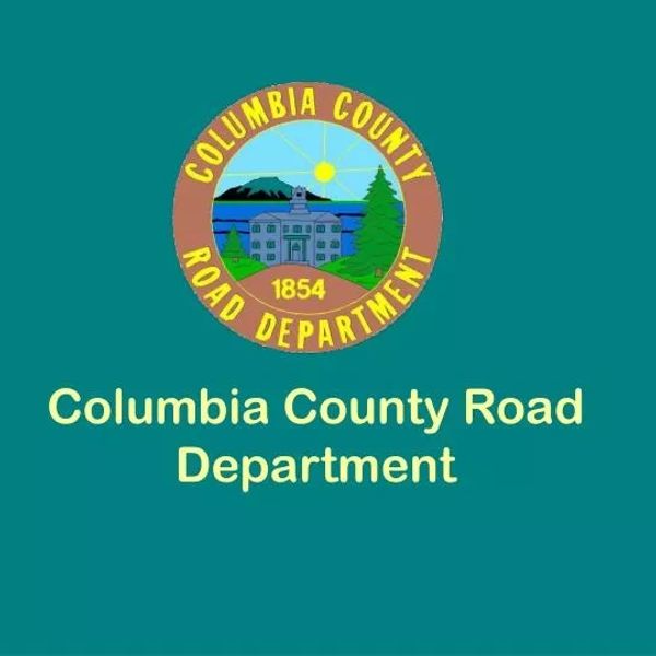 Logo of Columbia County Road Department with text and emblem.