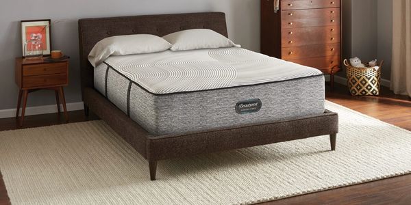 Beautyrest Quintessence mattress on a wooden bed frame in a bedroom