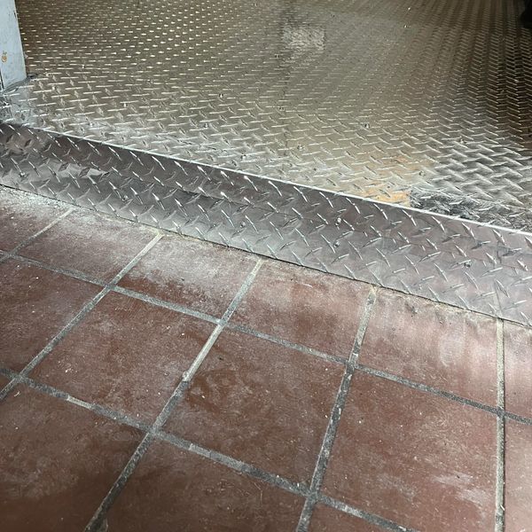 3003-H22 aluminum diamond plate restoration for a rusted walk-in cooler threshold in St. Petersburg.