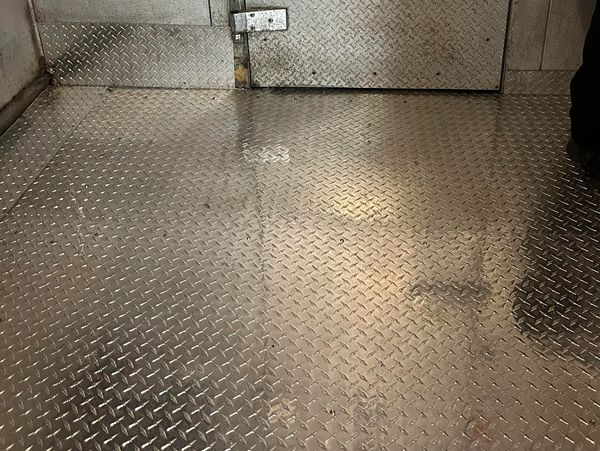 Rusted walk-in floor restoration using 3003 H22 aluminum diamond plate in Tampa Bay.