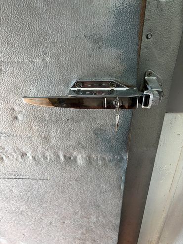 Kason 0058 Series locking latch installation with a recalibrated safety release for a walk-in door