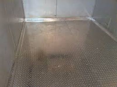 Metal diamond plate flooring in a confined space.