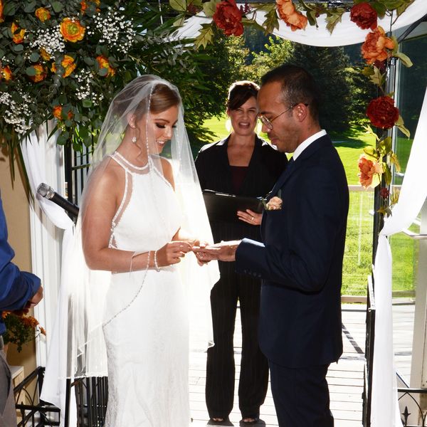 Bride and groom exchanging rings at wedding ceremony.