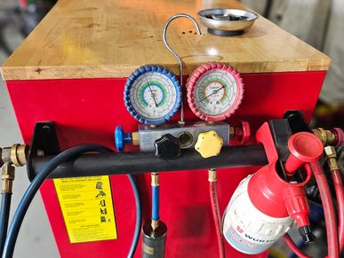 Air-conditioning service machine with gauges used for ARC-licensed A/C diagnostics and repairs.