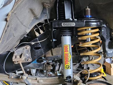 4WD suspension with Tough Dog shock and coil spring during upgrade installation.