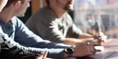 People on a table taking notes 