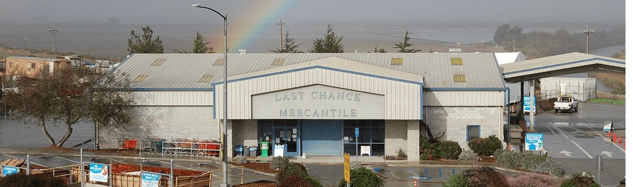 The image shows a building with the name "LAST CHANCE MERCANTILE" prominently displayed.