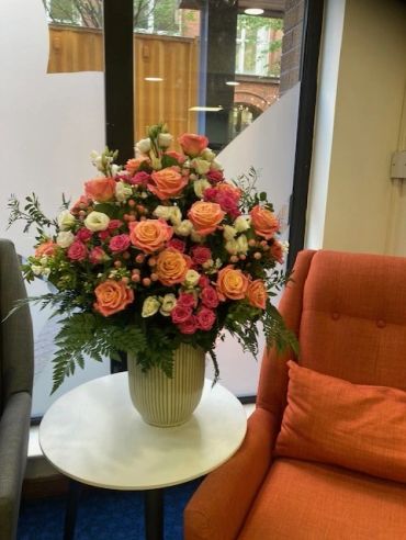 Vibrant floral arrangement in a white vase.