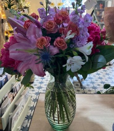 Colorful bouquet of flowers in a clear glass vase.