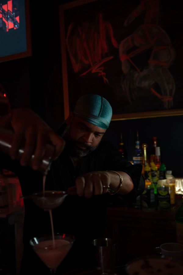 Bartender pouring cocktails.