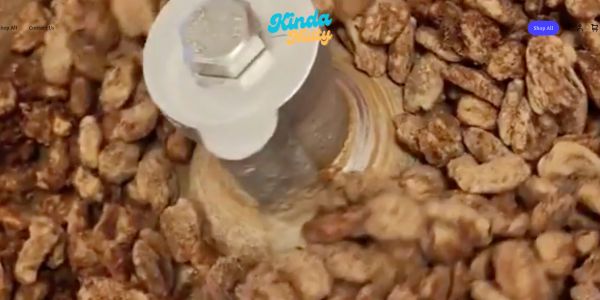 Candied nuts being mixed in a machine.
