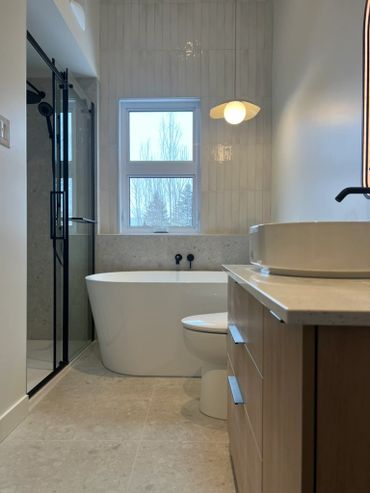 Modern bathroom with a freestanding tub and glass shower enclosure.