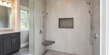 Spacious bathroom with dual showers and modern design.