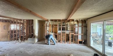 Person working on interior demolition of a room.