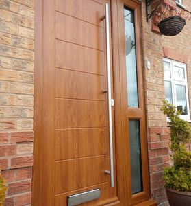 Golden Oak Solid Core front door with matching frame & mid rail side panel with a long bar handle.
