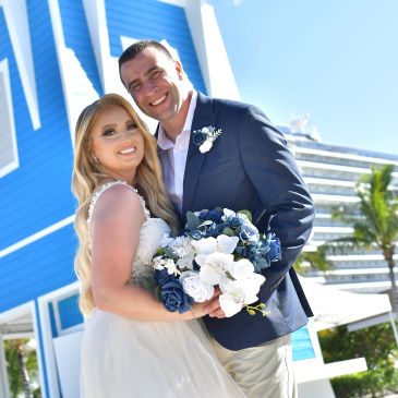 Happy couple in wedding attire posing outdoors.