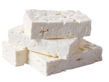 Stack of white cheese blocks with a crumbly texture.
