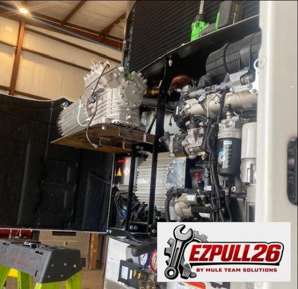 Industrial machinery setup inside a workshop with a visible engine and EZPULL26 logo.