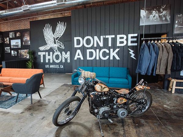 Motorcycle in a stylish showroom with bold wall text.