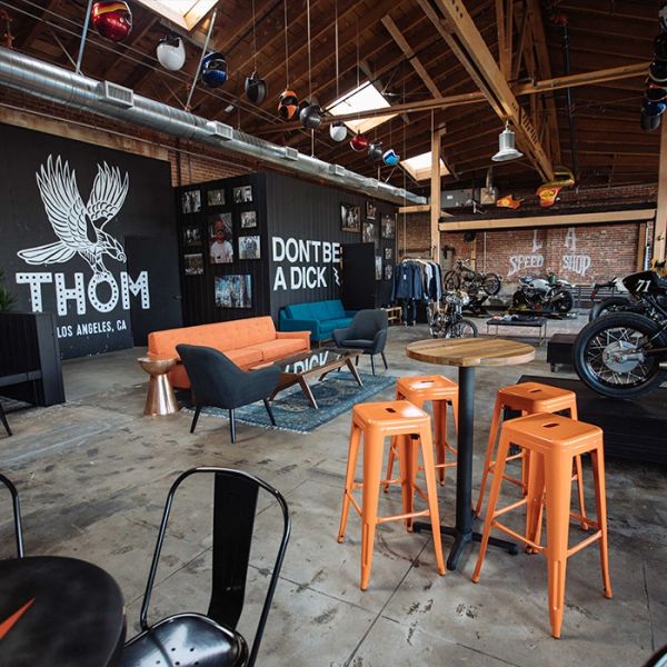 Trendy industrial lounge with vibrant furniture and motorcycles.