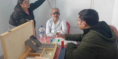 An eye examination being conducted with an optometrist and patient.