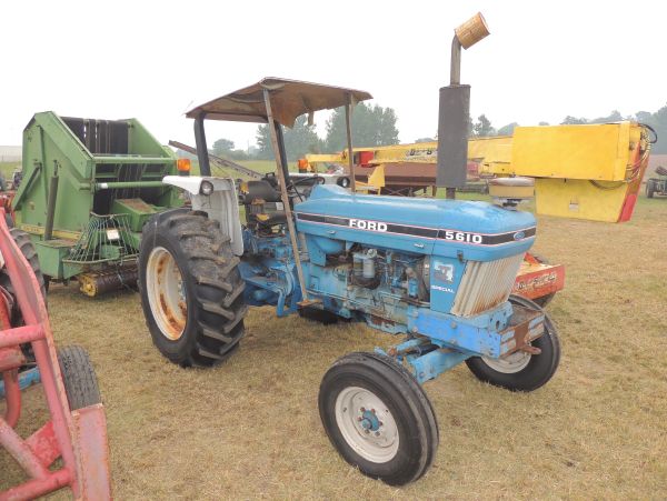 Blue Ford 5610 tractor on grass field.