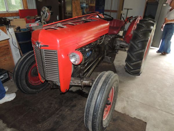 Vintage red tractor in a garage.