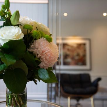 Close-up of a floral bouquet in a modern living room setting.