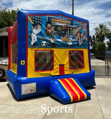 Colorful sports-themed bounce house outdoors.